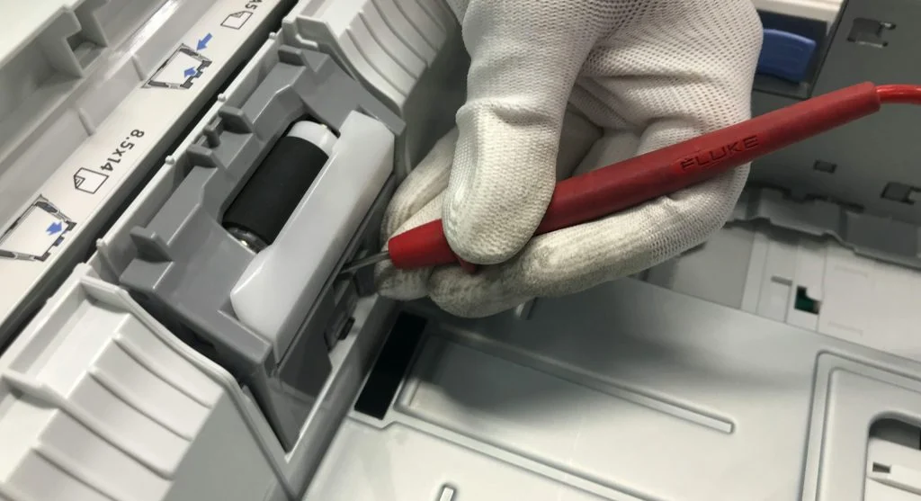 Person checking ink levels on a printer