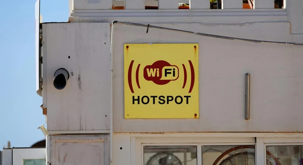 Person restarting a Wi-Fi router