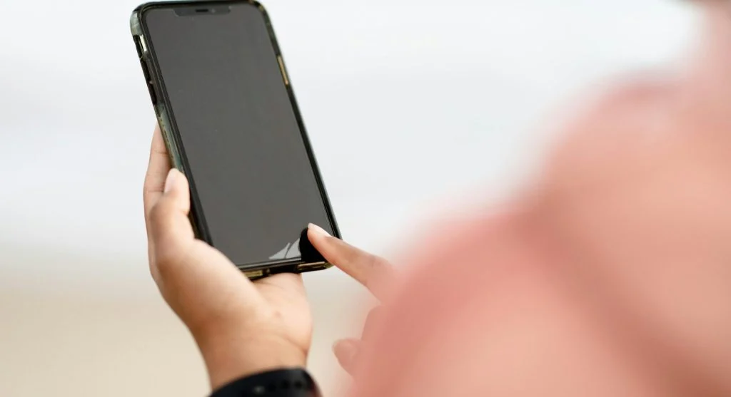 Screen protector on a device with a cracked screen in the background