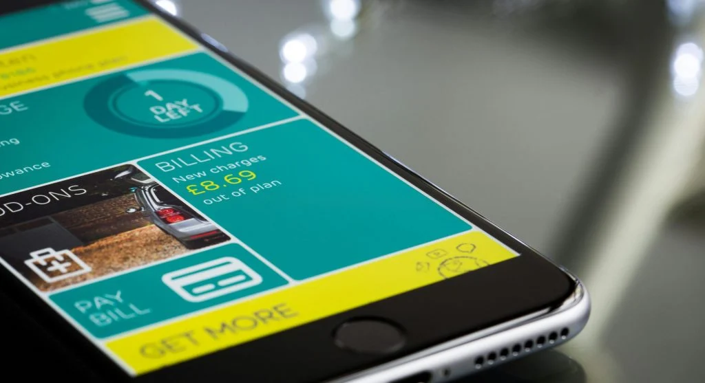 Person holding phone with mobile data usage tracking screen