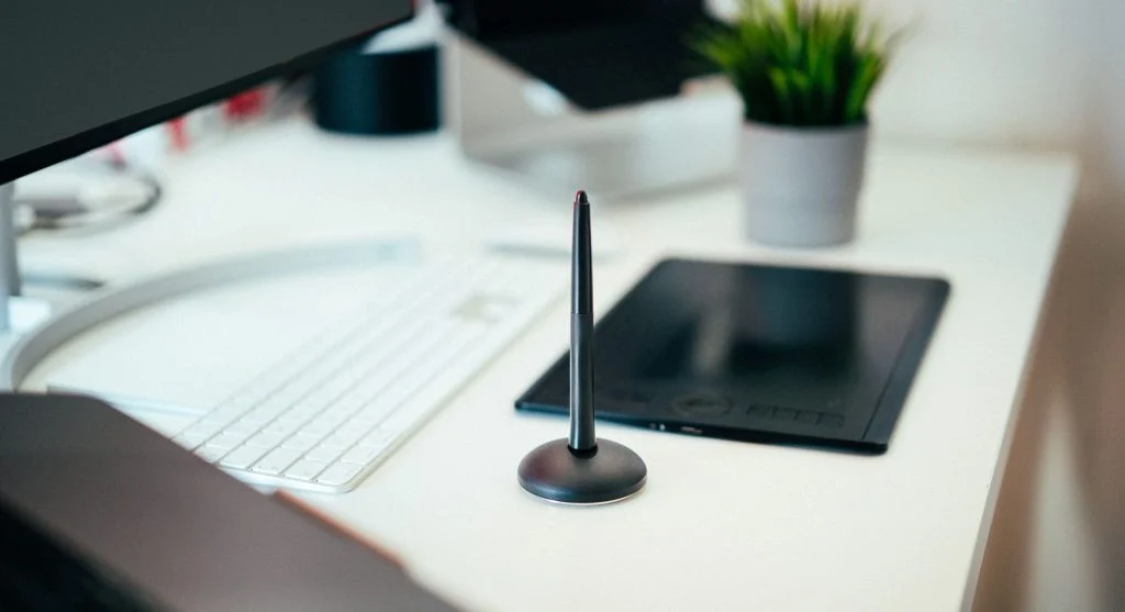 minimal desk with laptop and plant