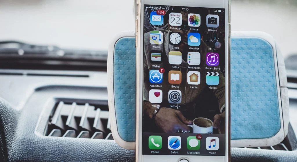 person holding smartphone with disappointed face